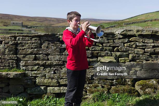 Reuben Owen takes time out from his chores to practice his Flugelhorn playing at Ravenseat, the farm of the Yorkshire Shepherdess Amanda Owen on...