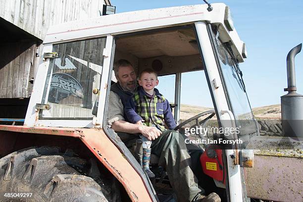 Sydney Owen sits in a tractor with his father Clive at Ravenseat, the farm of the Yorkshire Shepherdess Amanda Owen on April 15, 2014 near Kirkby...
