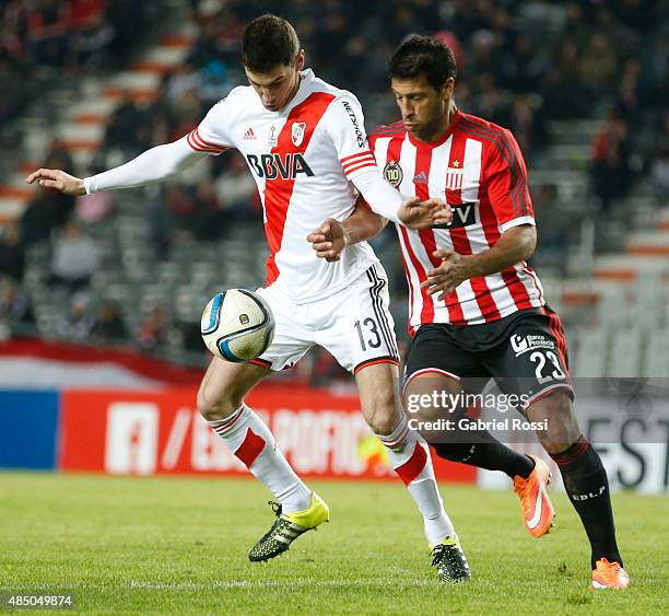 Lucas Alario of River Plate fights for the ball with Sebastian Dominguez of Estudiantes during a match between Estudiantes and River Plate as part of...