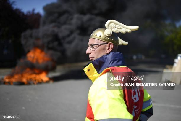 An employee of the "Seita-Imperial tobacco" plant in Carquefou wears the symbolic cask of comic book hero Asterix during a protest at the entrance of...