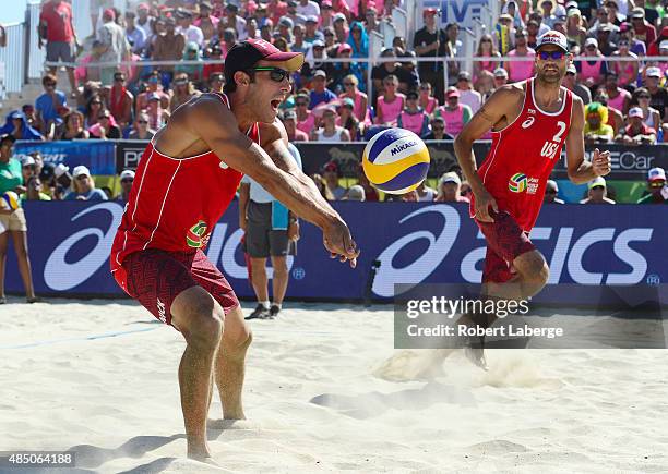 Nicholas Lucena of the USA sets the Mikasa as Philip Dalhausser looks on during the 2015 ASICS World Series of Beach Volleyball at the TrueCar Course...