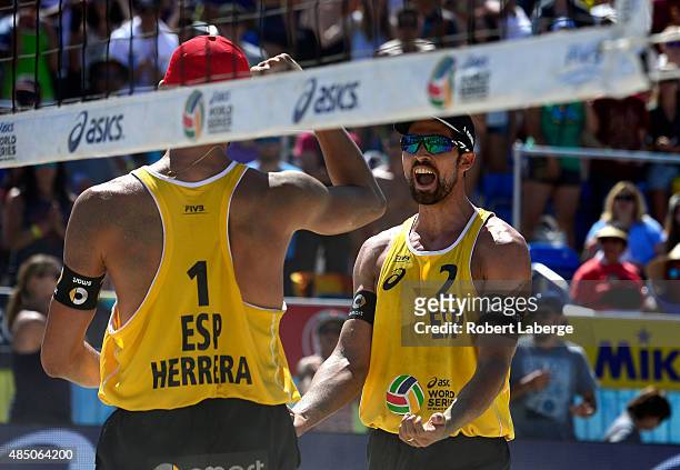 Robert Meeuwsen of the Netherlands tries to block the spike by Pablo Herrera Allepuz of Spain during the 2015 ASICS World Series of Beach Volleyball...