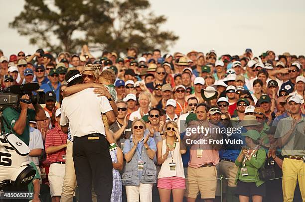 Bubba Watson victorious, hugging wife Angie and son Caleb after winning tournament during Sunday play at Augusta National. Augusta, GA 4/13/2014...