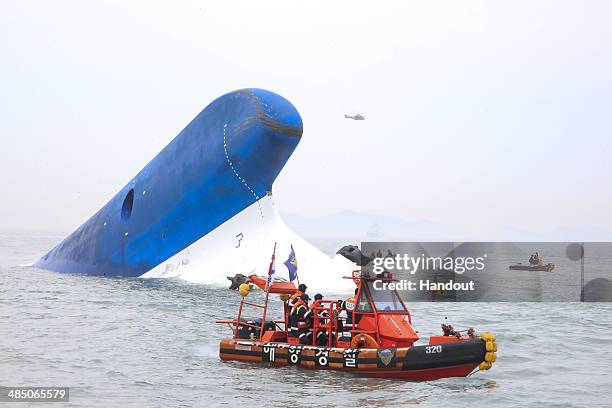 In this handout provided by Donga Daily, The Republic of Korea Coast Guard work at the site of ferry sinking accident off the coast of Jindo Island...