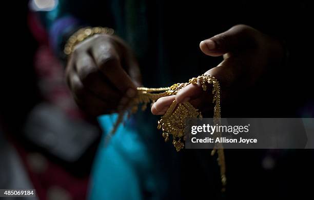Gold wedding jewelry is laid out for 15 year old Nasoin Akhter on the day of her wedding to a 32 year old man, August 20, 2015 in Manikganj,...
