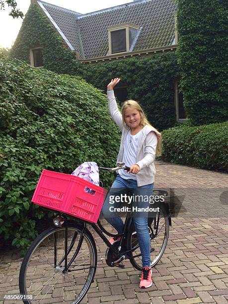 In this handout provided by Netherlands Government Information Service, Crown Princess Amalia of The Netherlands waves on her first day of attending...