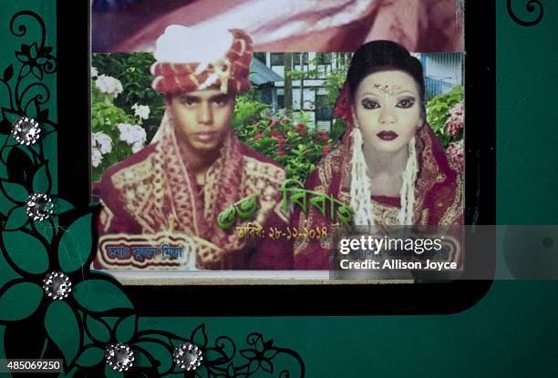 Year old Mohammad Sujon Mia and his wife, 14 year old Mousammat Akhi Akhter, are pictured in their wedding photo August 19, 2015 in Manikganj,...