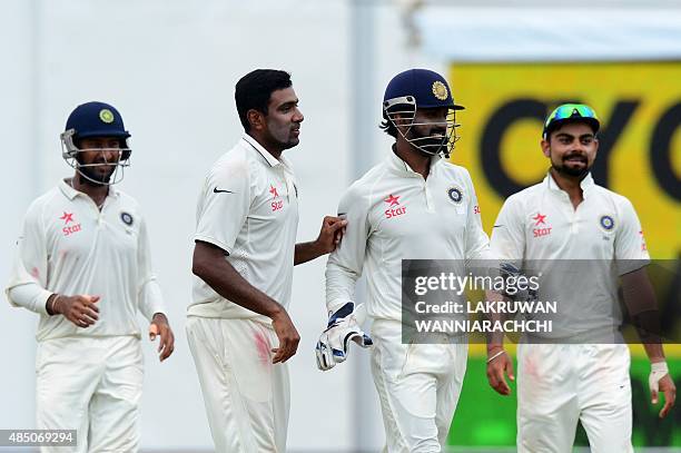 Indian cricketer Ravichandran Ashwin celebrates with his teammates after he dismissed Sri Lankan cricketer Dinesh Chandimal during the final day of...