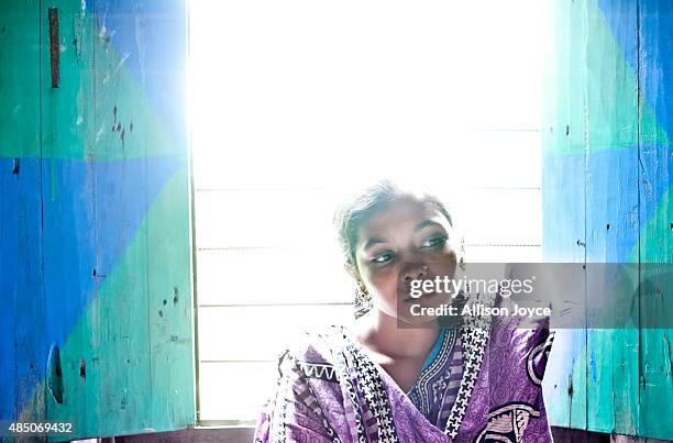 Year old Mousammat Akhi Akhter poses in her home August 19, 2015 in Manikganj, Bangladesh. Last year, when she was only 13, Akhi got married a 27...