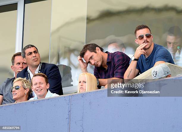 Injured Frank Lampard of the New York City FC and Claudio Reyna , director of football operations for New York City FC, attend the MLS soccer match...