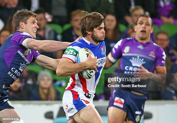 Jake Mamo of the Newcastle Knights runs with the ball during the round 24 NRL match between the Melbourne Storm and the Newcastle Knights at AAMI...