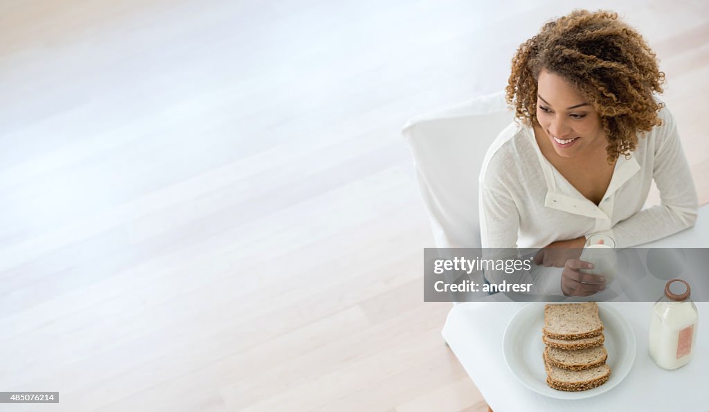 Woman having breakfast at home