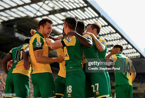 Russell Martin of Norwich City is mobbed as he celebrates his equalising goal during the Barclays Premier League match between Norwich City and Stoke...