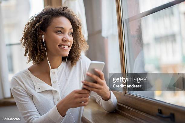 woman using app to listen to music - radio listening stock pictures, royalty-free photos & images