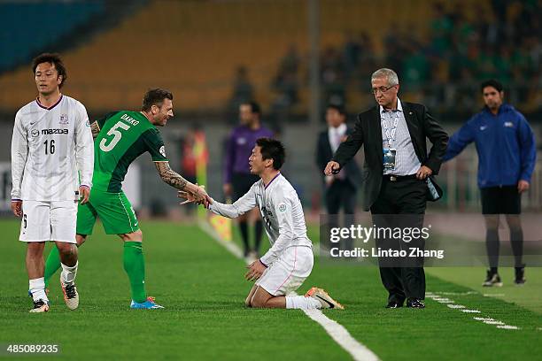 Yojiro Takahagi of Sanfrecce Hiroshima shakes hands with Matic Darko of Beijing Guo'an during the AFC Champions match between Sanfrecce Hiroshima and...