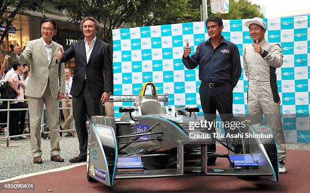 Lower House lawmaker Keiji Furuya, Formula E CEO Alejandro Agag, former Formula One driver Aguri Suzuki and driver Sakon Yamamoto pose for...