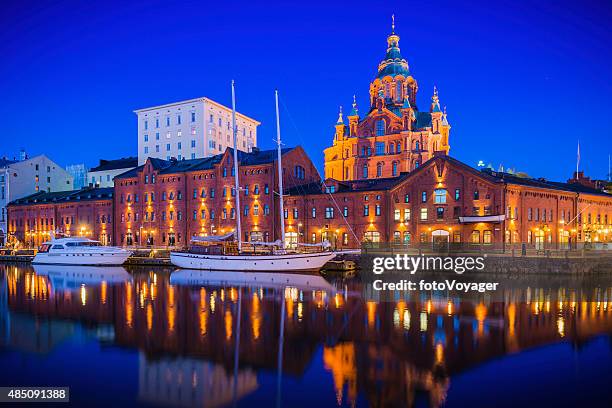 helsinki uspenski cathedral reflecting in illuminated marina tranquil waterfront finland - helsinki stock pictures, royalty-free photos & images