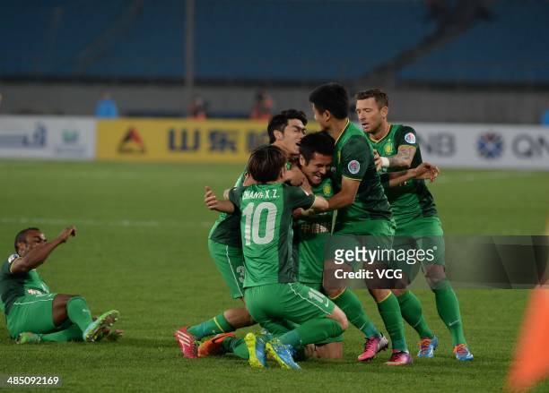 Shao Jiayi of Beijing Guo'an celebrates with team mates after scoring his team's first goal during the Asian Champions League match between Beijing...
