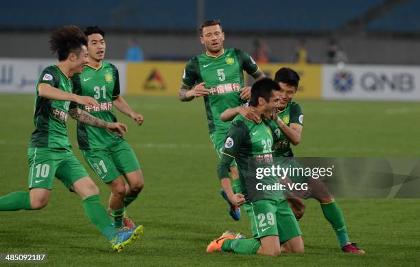 Shao Jiayi of Beijing Guo'an celebrates with team mates after scoring his team's first goal during the Asian Champions League match between Beijing...