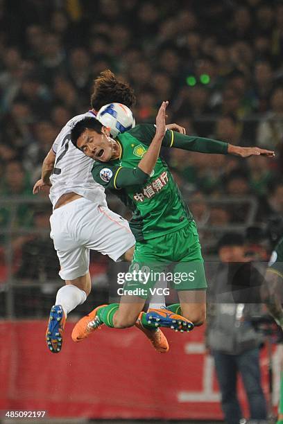 Shao Jiayi of Beijing Guo'an and Hwang Seok-Ho of Sanfrecce Hiroshima battle for the ball during the Asian Champions League match between Beijing...