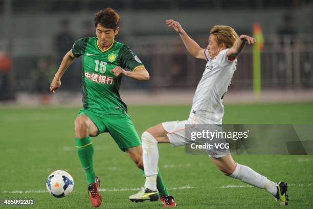 Ha Dae-Sung of Beijing Guo'an and Naoki Ishihara of Sanfrecce Hiroshima battle for the ball during the Asian Champions League match between Beijing...