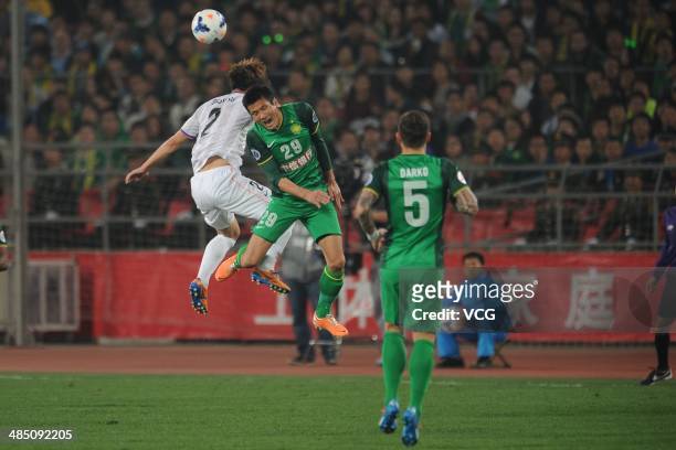 Shao Jiayi of Beijing Guo'an and Hwang Seok-Ho of Sanfrecce Hiroshima battle for the ball during the Asian Champions League match between Beijing...