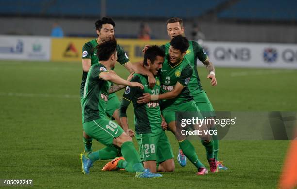 Shao Jiayi of Beijing Guo'an celebrates with team mates after scoring his team's first goal during the Asian Champions League match between Beijing...