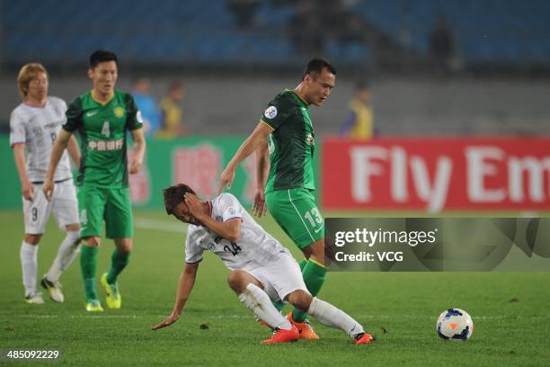 Xu Yunlong of Beijing Guo'an and Gakuto Notsuda of Sanfrecce Hiroshima battle for the ball during the Asian Champions League match between Beijing...