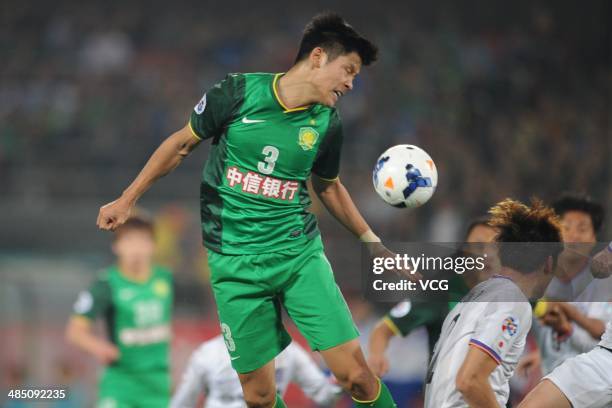 Yu Yang of Beijing Guo'an jumps to head the ball during the Asian Champions League match between Beijing Guo'an and Sanfrecce Hiroshima at Workers...