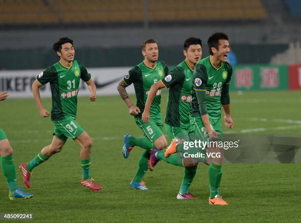 Shao Jiayi of Beijing Guo'an celebrates with team mates after scoring his team's first goal during the Asian Champions League match between Beijing...