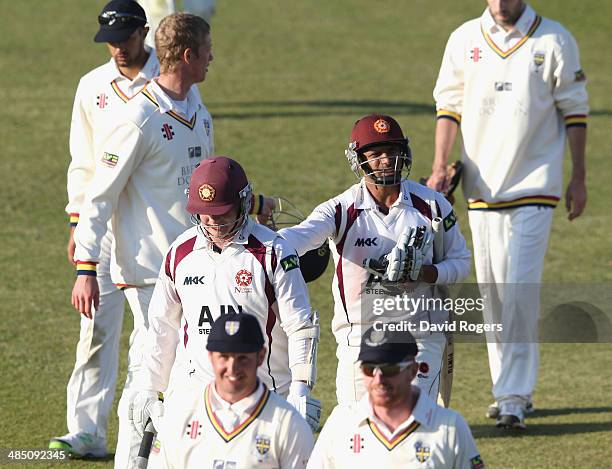 Mohammad Azharullah and Rob Newton of Northamptonshire walk off the pitch as they hold on for a ninth wicket stand to enable Northamptonshire to...