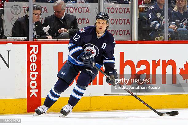 Olli Jokinen of the Winnipeg Jets keeps an eye on the play during first period action against the Boston Bruins at the MTS Centre on April 10, 2014...