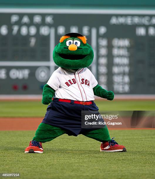 Wally the Green Monster, the official mascot of the Boston Red Sox, stands in the infield before a game between the Boston Red Sox and the Cleveland...