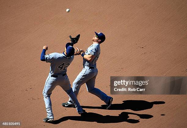 Second baseman Logan Forsythe of the Tampa Bay Rays looks on as first baseman James Loney of the Tampa Bay Rays catches a pop up hit by Nelson Cruz...