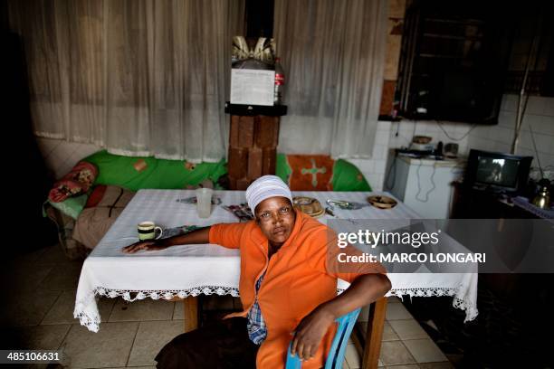 Patient sits at a table at a facility in the derelict Chris Hani informal settlement in the outskirts of Hammanskraal on April 16, 2014. In the...