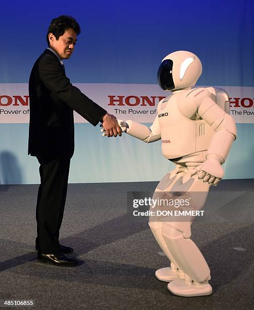 Honda's Satoshi Shigemi works with Asimo Robot as Honda North America makes their North American debut of Asimo Robot at a news conference...