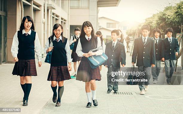 first day of school in japan - school students uniform walking stock pictures, royalty-free photos & images