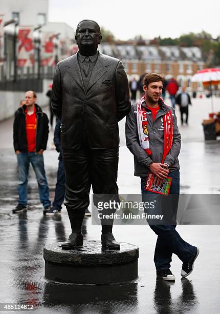 Liverpool fan stands by a statue of former Arsenal manager Herbert Chapman prior to the Barclays Premier League match between Arsenal and Liverpool...