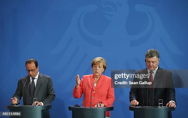 German Chancellor Angela Merkel, Ukrainian President Petro Poroshenko and French President Francois Hollande speak to the media following talks at...