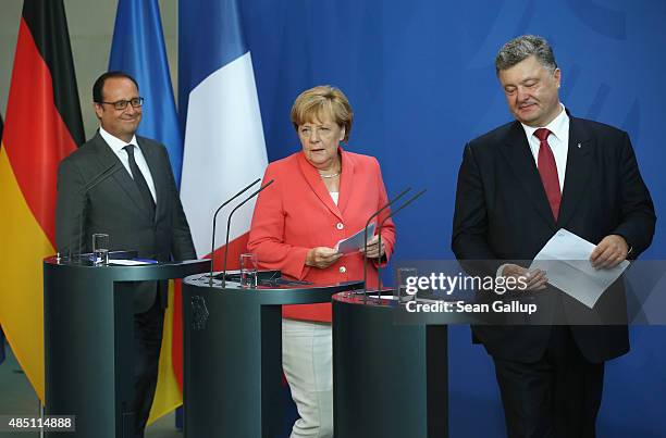 German Chancellor Angela Merkel, Ukrainian President Petro Poroshenko and French President Francois Hollande arrive to speak to the media following...