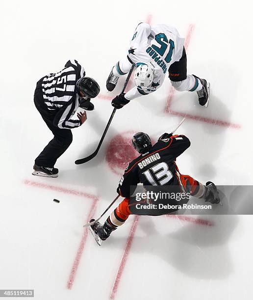 Linesman Jay Sharrers drops the puck for the face off between Nick Bonino of the Anaheim Ducks and James Sheppard of the San Jose Sharks on April 9,...