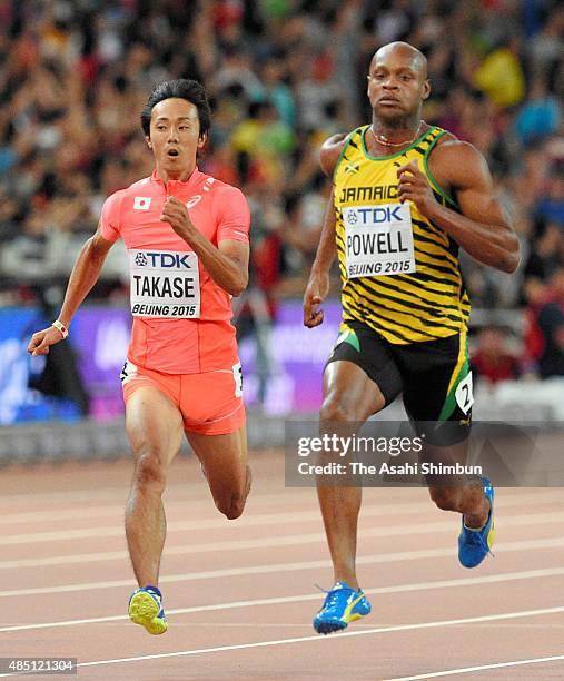 Kei Takase of Japan and Asafa Powell of Jamaica compete in the Men's 100m heat during day one of the 15th IAAF World Athletics Championships Beijing...