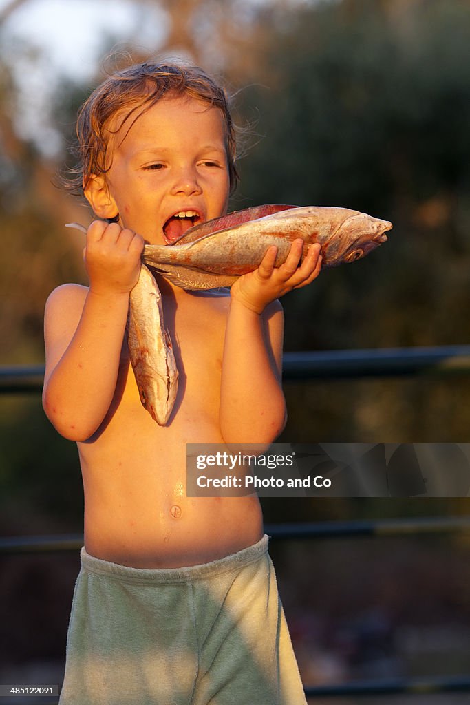 Child holding fish