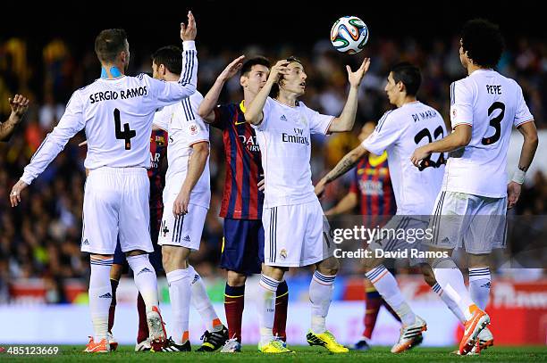 Lionel Messi of FC Barcelona argues with Luka Modric of Real Madrid CF during the Copa del Rey Final between Real Madrid and FC Barcelona at Estadio...