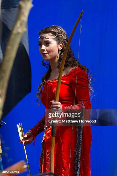 Jenna Coleman spotted wearing an orange medieval dress and holding a bow and arrow during filming for the eighth series of BBC show Doctor Who at...