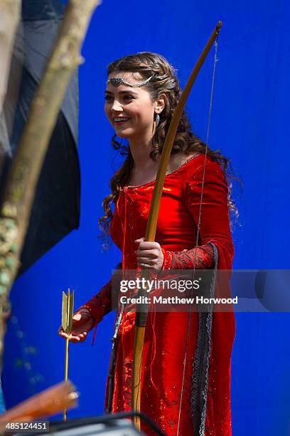 Jenna Coleman spotted wearing an orange medieval dress and holding a bow and arrow during filming for the eighth series of BBC show Doctor Who at...