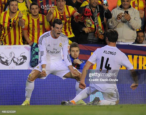 Gareth Bale of Real Madrid celebrates beside Xabi Alonso after scoring Real's 2nd goal during the Copa del Rey Final between Real Madrid and...