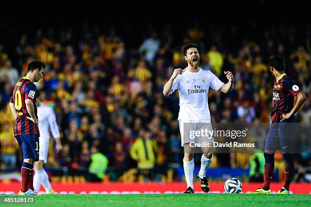 Xabi Alonso of Real Madrid CF celebrates past Lionel Messi and Neymar of FC Barcelona'aftyer his teammate Gareth Bale of Real Madrid CF scored the...