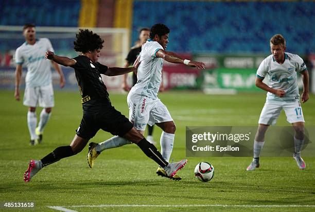 Mauricio Lemos of FC Rubin Kazan is challenged by Hulk of FC Zenit Saint Petersburg during the Russian Premier League match between FC Rubin Kazan...