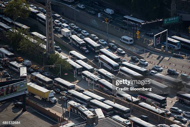 Buses and cars sit in traffic at the Lincoln Tunnel in this aerial photograph taken above North Bergen, U.S., on Friday, Aug. 21, 2015. New Jersey...